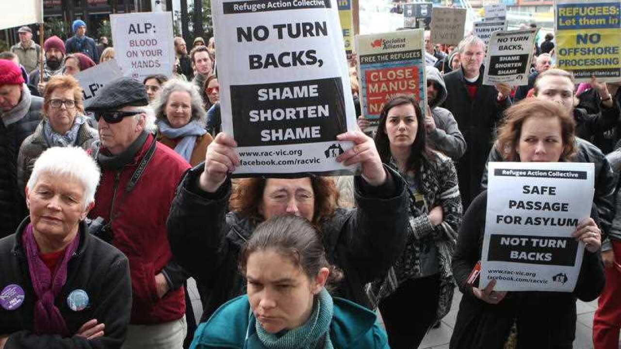 Protesters against refugee processing centres gather outside the Australian Labor Party conference held at the Melbourne convention centre.