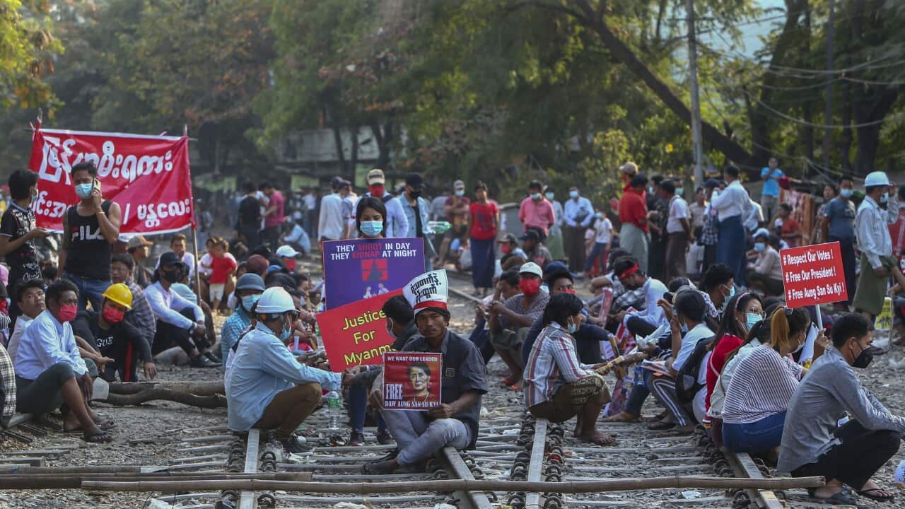 Anti-coup demonstrators are seen on February 17 sitting on railway tracks in Mandalay, Myanmar