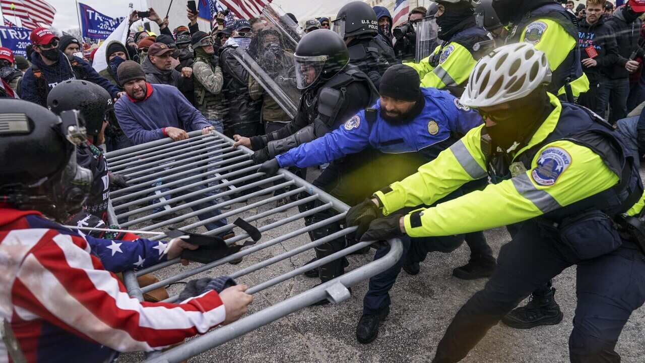 Trump supporters try to break through a police barrier, Wednesday, Jan. 6, 2021, at the Capitol in Washington.