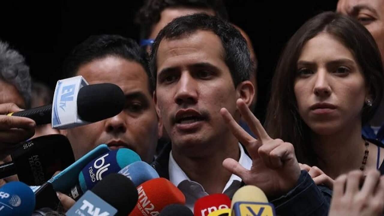 Juan Guaido (C), Venezuela's self-proclaimed interim president, is urging the military to back him.