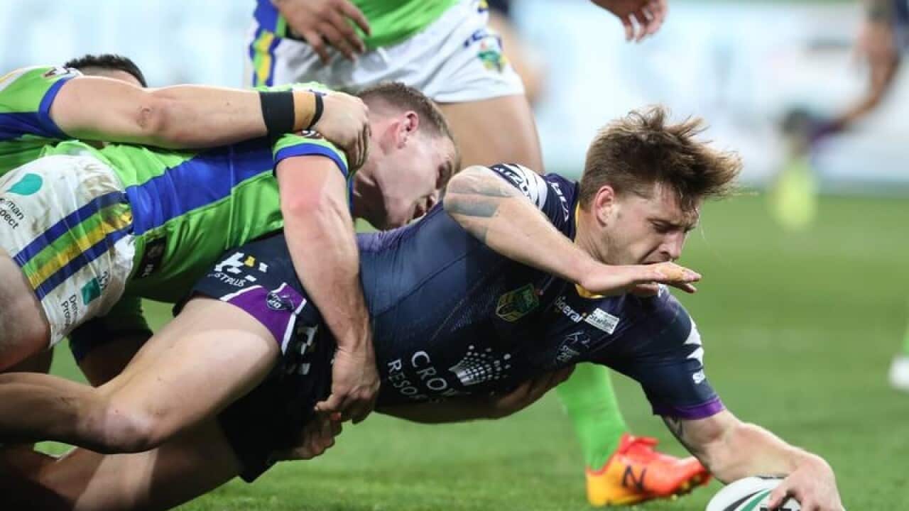 Cameron Munster scores a try for the Storm against the Raiders.
