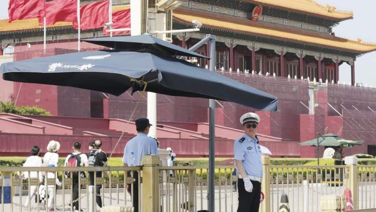 Police stand guard in Tiananmen Square