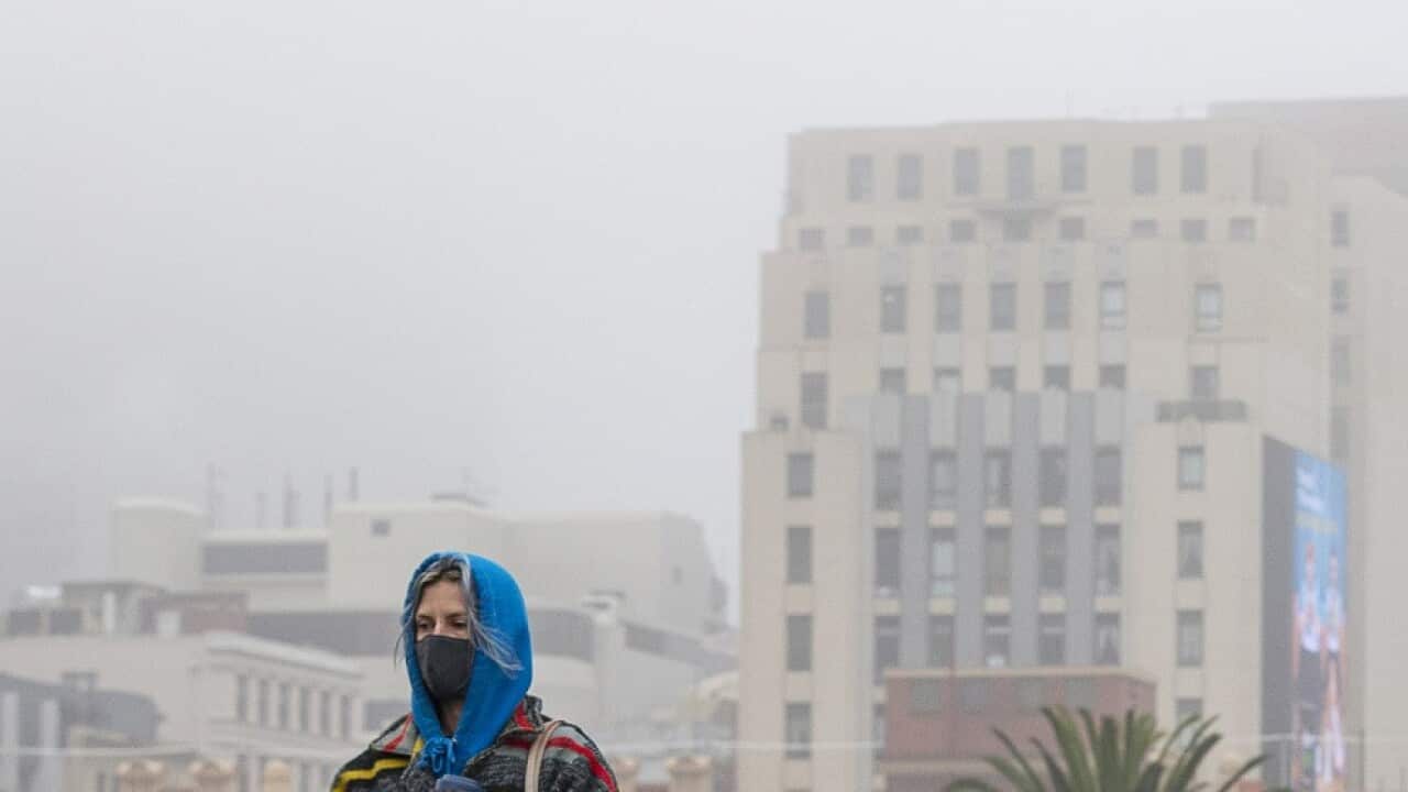 People are seen walking along the Princes Bridge in Melbourne, Friday, July 17, 2020. (AAP Image/Daniel Pockett) NO ARCHIVING