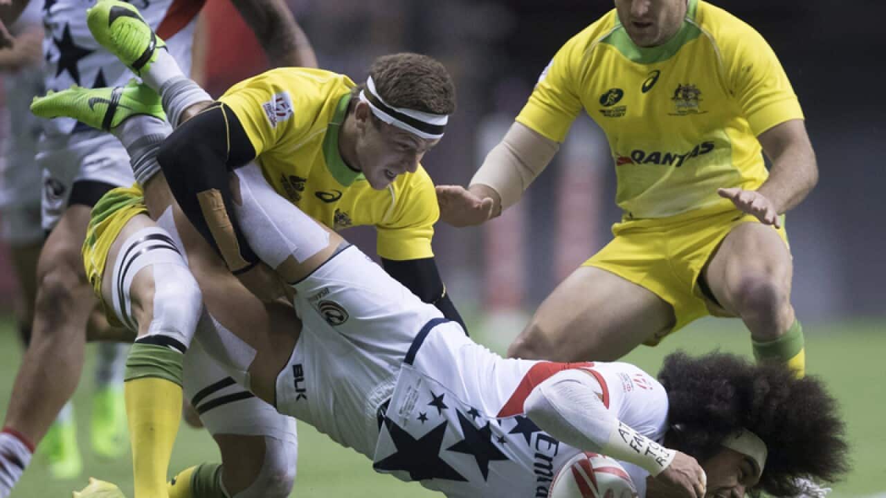 US' Folau Niua (R) is tackled by Australia's Nicholas Malouf (L)