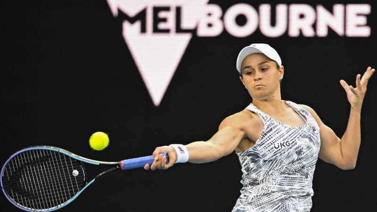 Ash Barty makes a shot at the Australian Open.