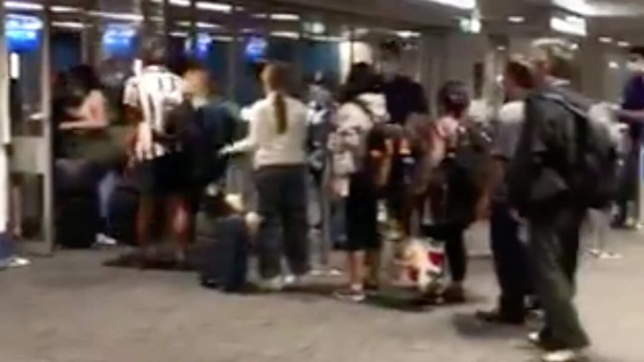 Returning overseas travellers line up in the arrivals area of Sydney Airport.