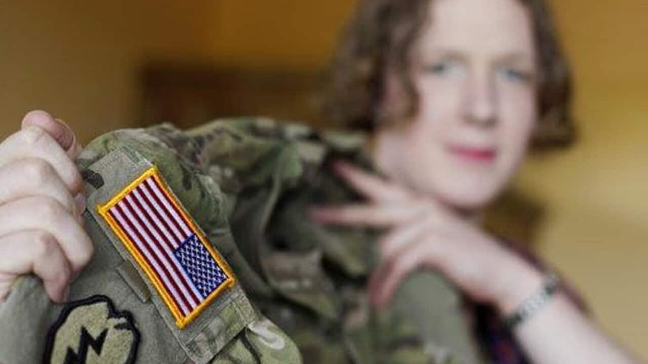 Transgender U.S. Army captain Jennifer Sims lifts her uniform.