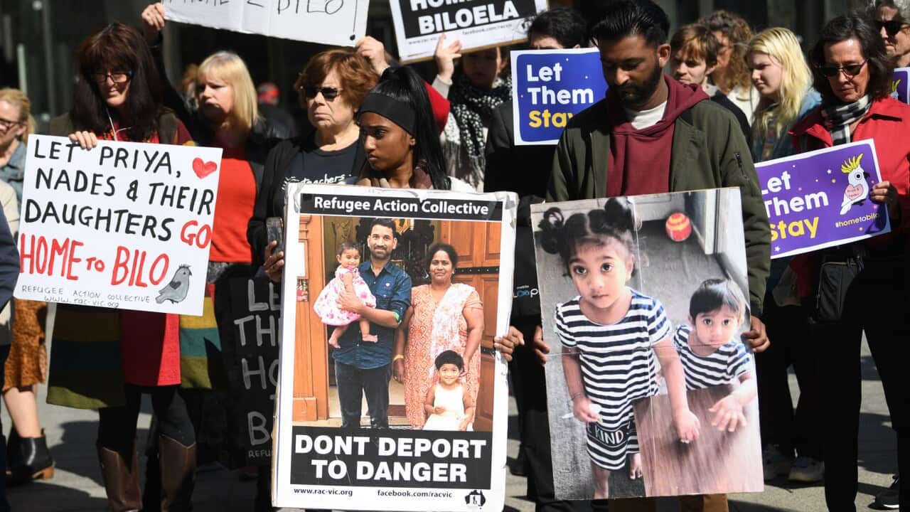 Supporters of the family gather outside the Federal Court in Melbourne.