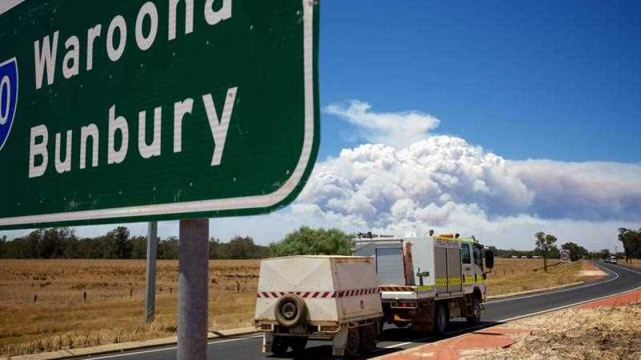 Smoke clouds caused by a large bush fire near the town of Waroona and the surrounding area seen from the turn off to the South Western Highway near Pinjarra, Western Australia.