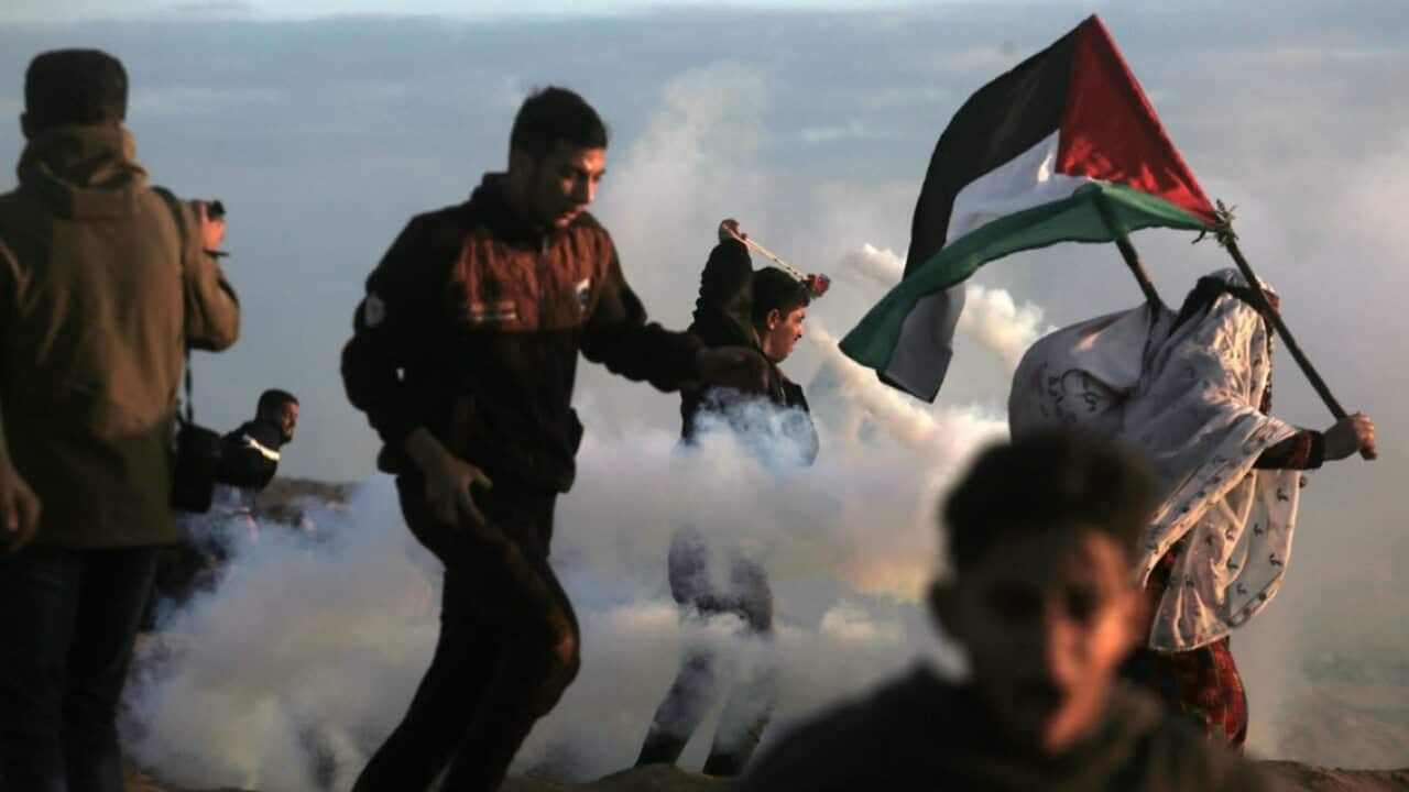 Palestinian protesters during the clashes after Friday protests near the border between Israel and Gaza Strip in the east Gaza Strip, 21 December 2018 (AAP)