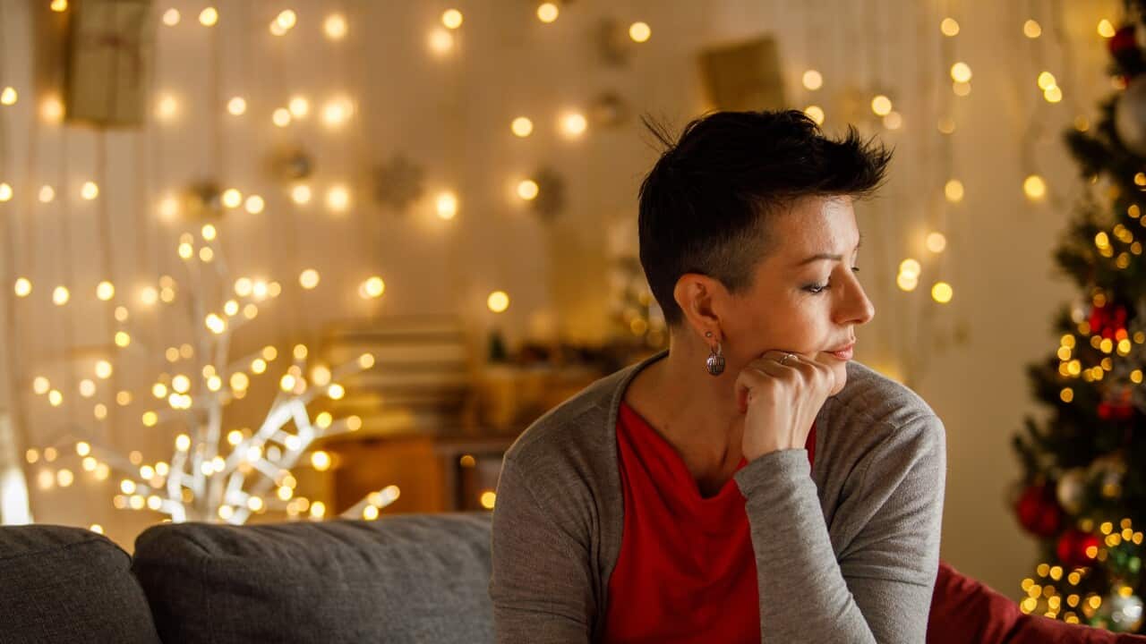 Contemplative Woman Enjoying Serene Atmosphere During Christmas Season