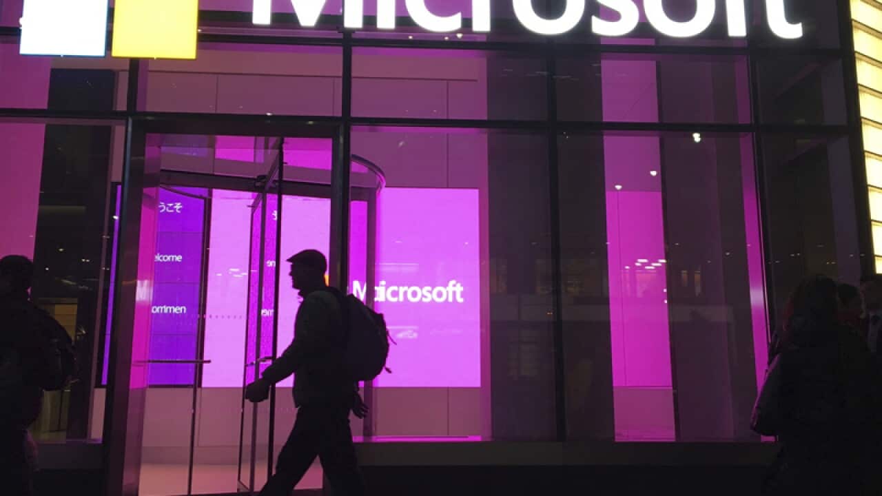People walk near a Microsoft office in New York