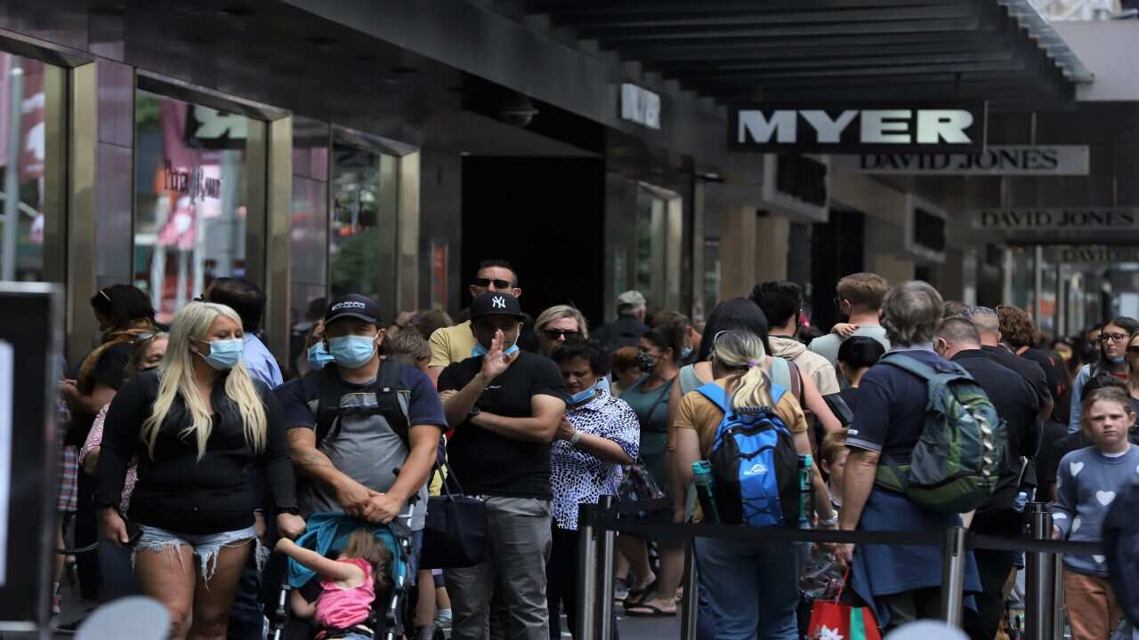 People wait to check Myer Christmas windows along Bourke Street Mall in Melbourne on 5 December 2021.