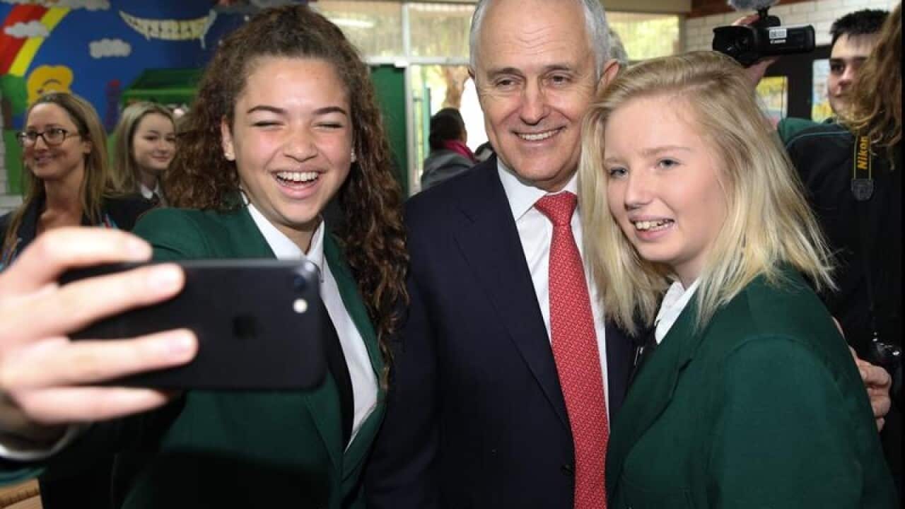 Prime Minister Malcolm Turnbull poses for a selfie with students