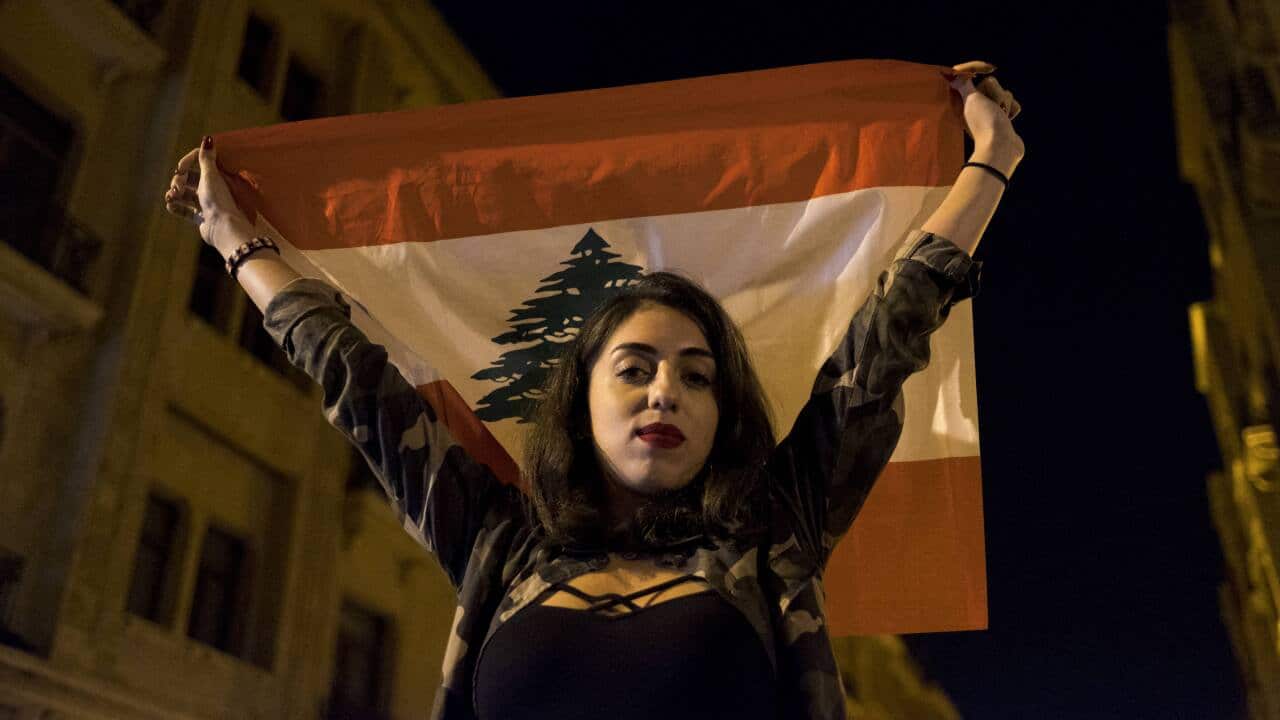Thousands of Lebanese protests, waving their national flag as part of anti-government protests across the country.