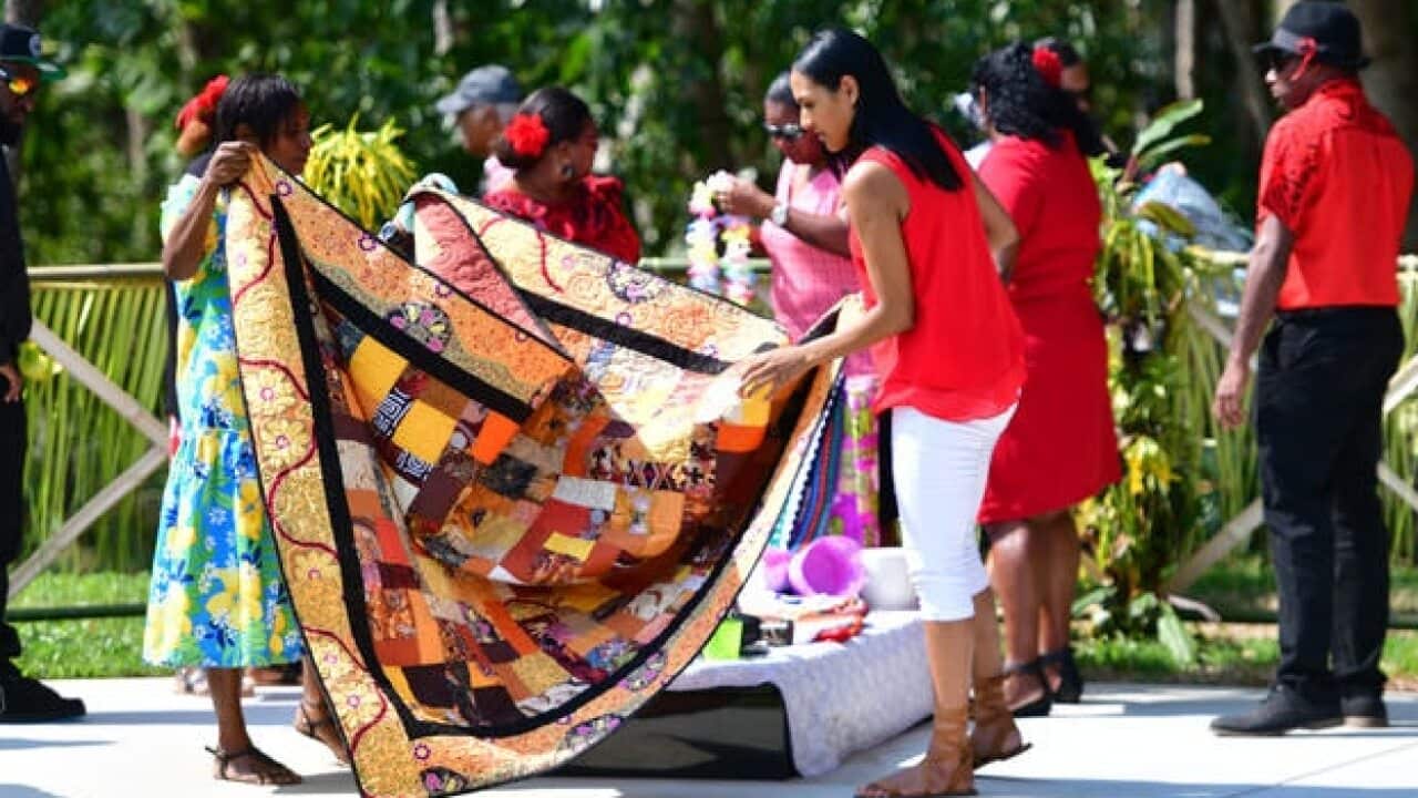 Family members unveil the children's tombstones for the first time.