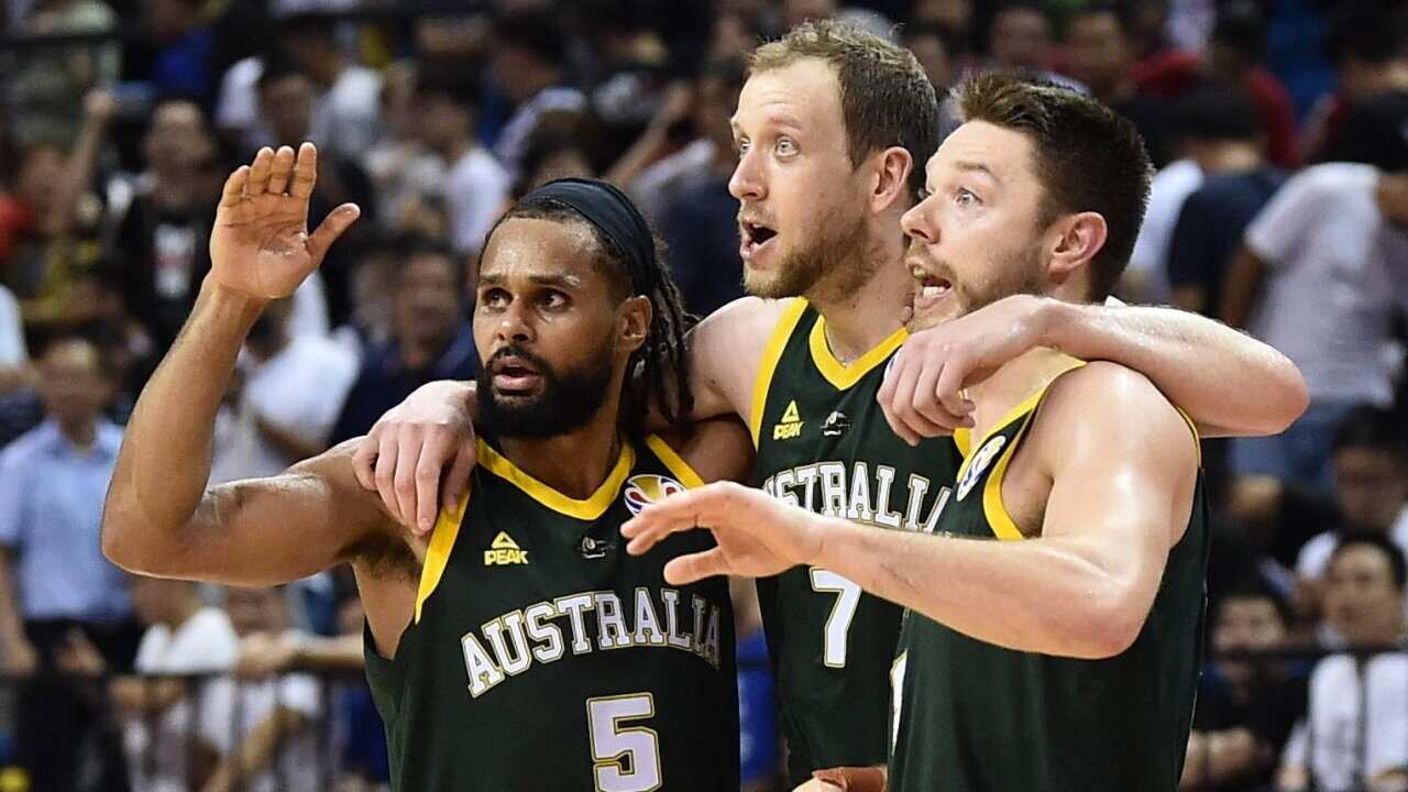From left, Australia's Patty Mills, Joe Ingles and Matthew Dellavedova look on during the second round Group L match against France in the FIBA 2019.