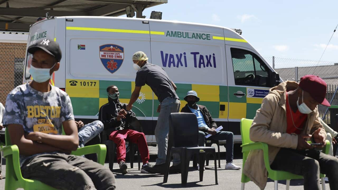 People wait to be vaccinated at a mobile 'Vaxi Taxi' in Capetown, S Africa