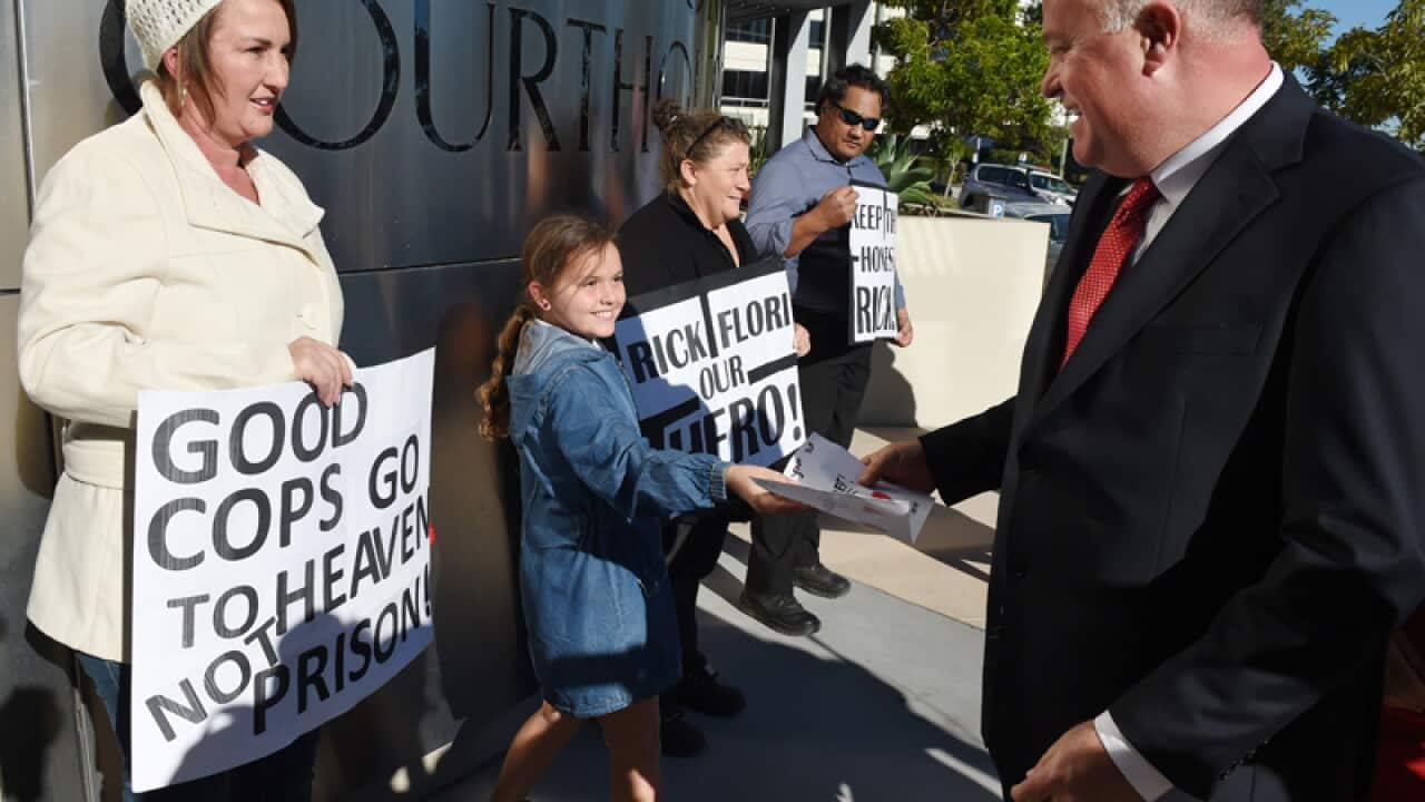 Queensland Police sergeant Rick Flori is cheered on by supporters