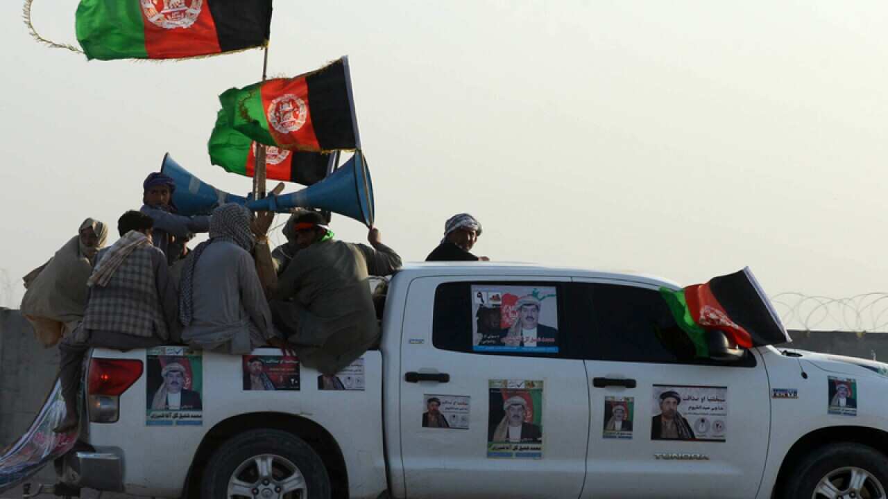 Afghan supporters take part in an election campaign rally