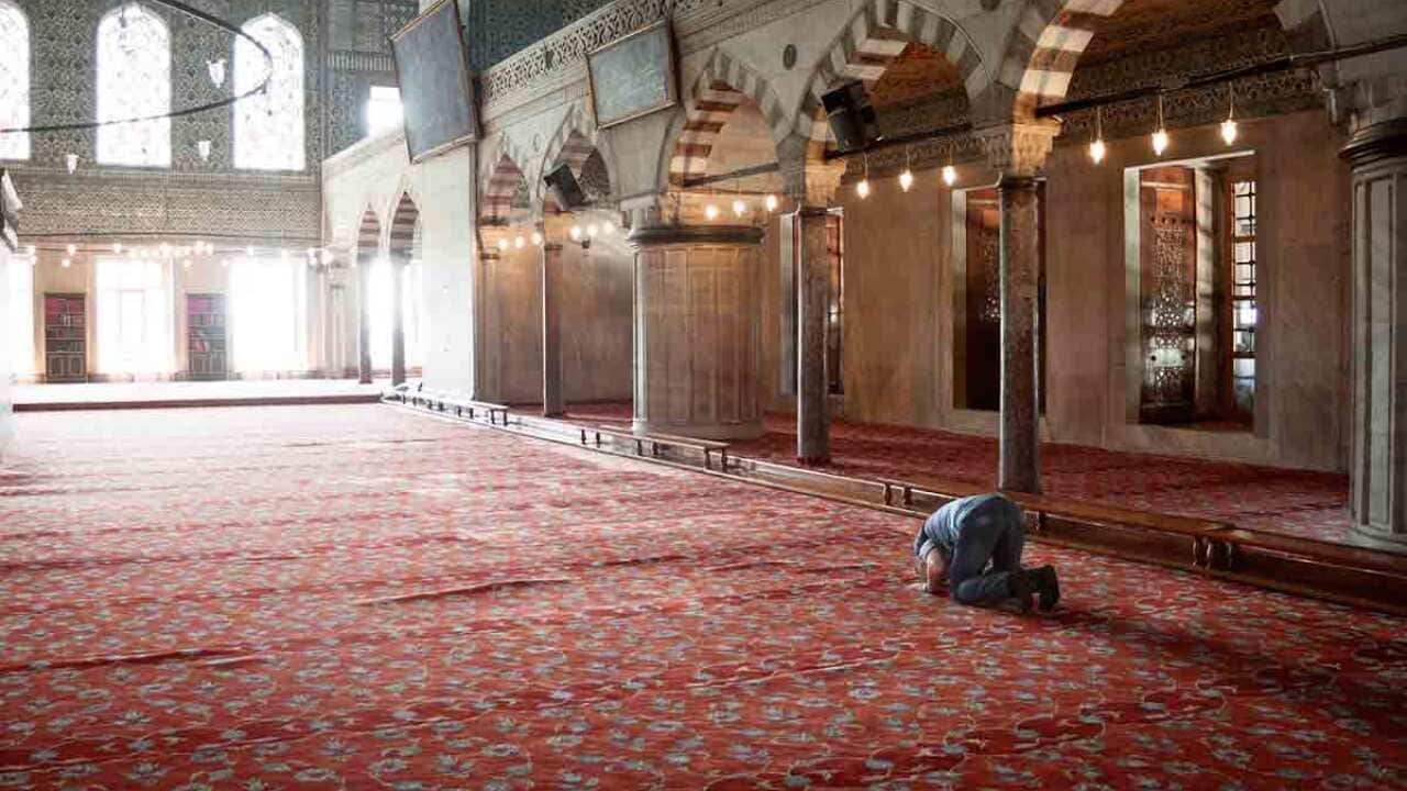 Man praying in a mosque