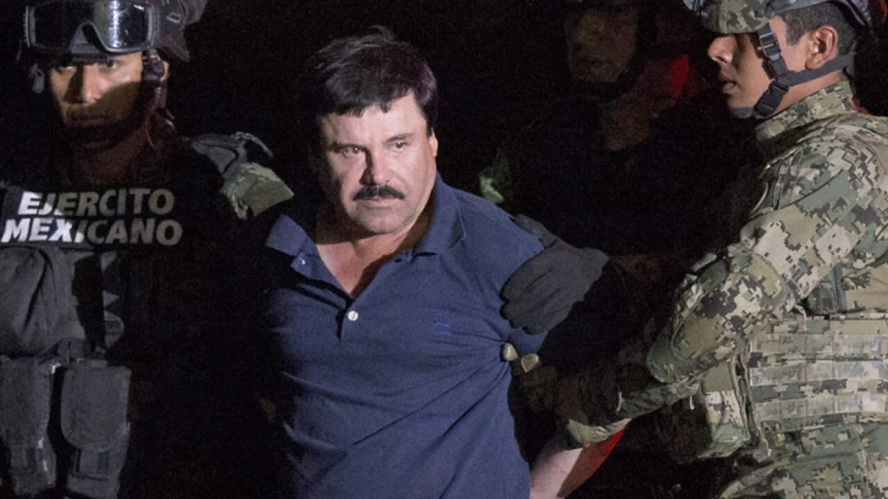 Drug lord Joaquin "El Chapo" Guzman is escorted by army soldiers