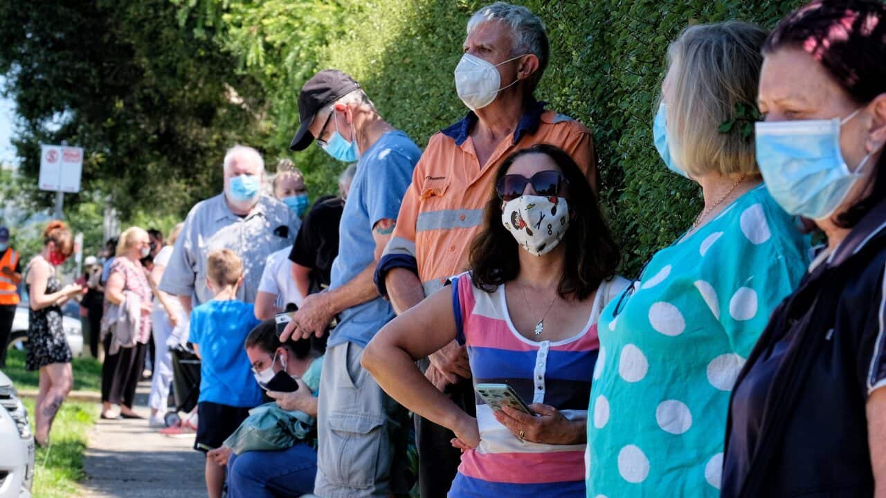 People line up to be tested for COVID-19 at the Sunbury Respiratory Clinic in Melbourne.