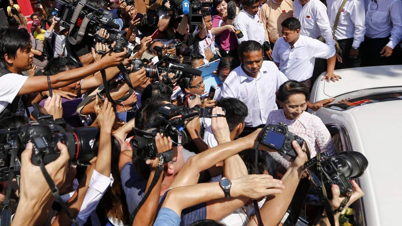 Myanmar opposition leader Aung San Suu Kyi (R), chairperson of National League for Democracy (NLD) party, leaves NLD headquarters after delivered a speech. (EPA)
