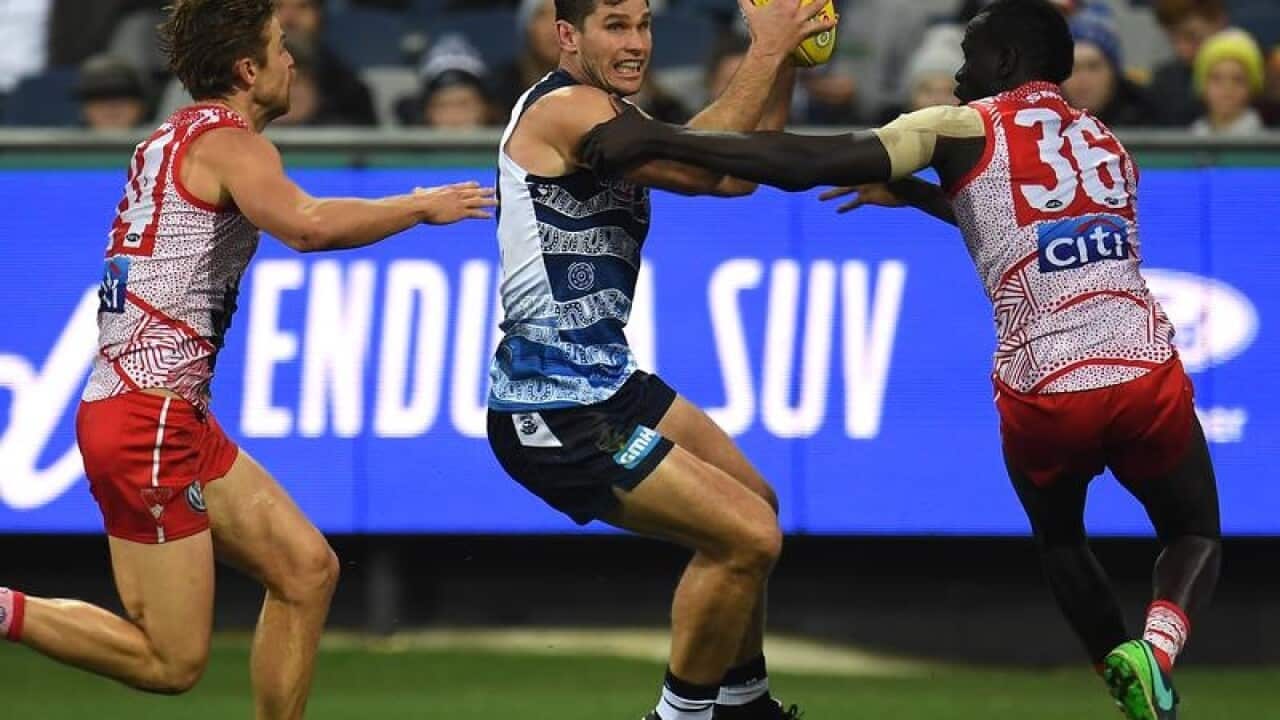 Geelong's Tom Hawkins with the ball.