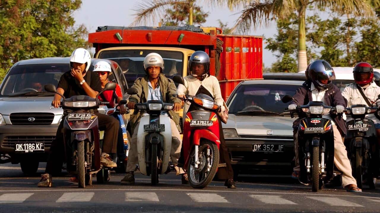 Motorbike riders at Kuta, Bali.