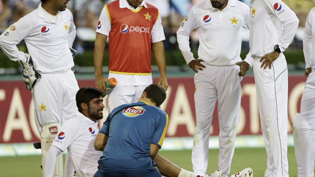 Pakistan bowler Mohammad Amir is assisted by medical staff