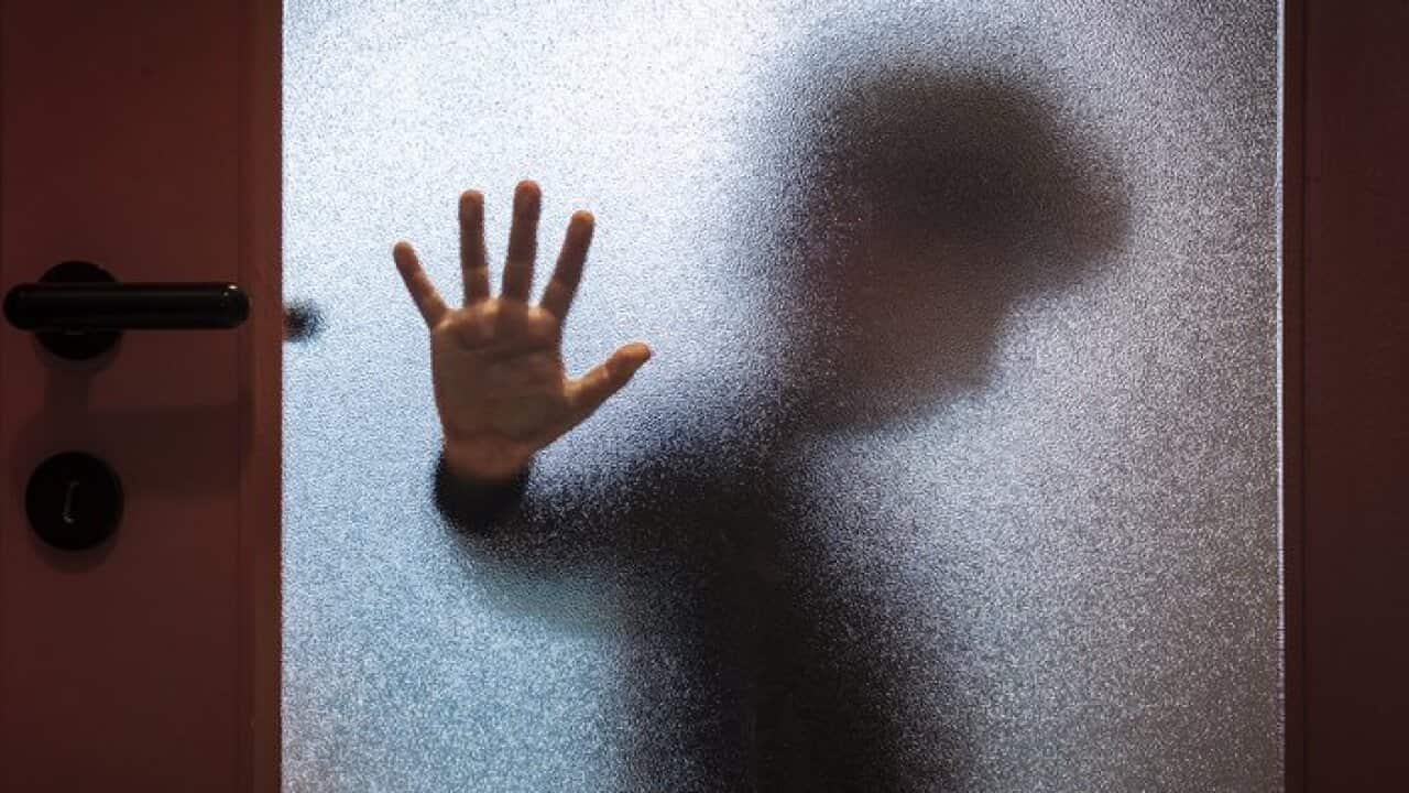 Boy Behind Glass Door