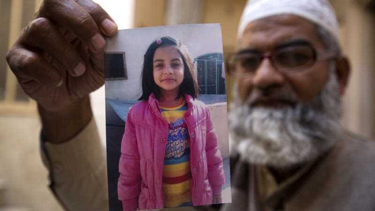 In this Thursday, Jan. 18, 2018 photo, Mohammed Amin shows a picture of his seven year-old daughter, Zainab Ansari in Kasur, Pakistan.