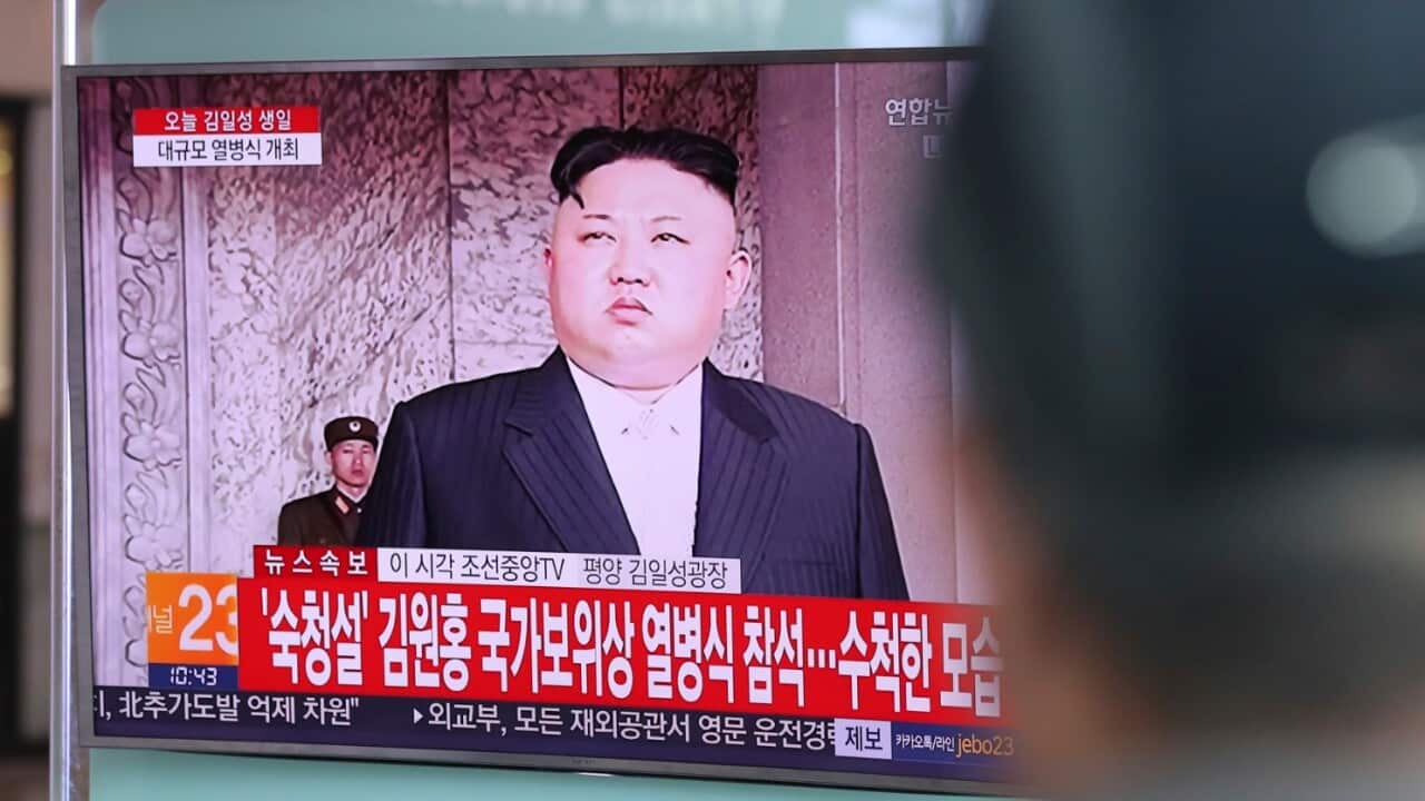 A man watches a live television program showing North Korean leader Kim Jong Un during the day of the sun