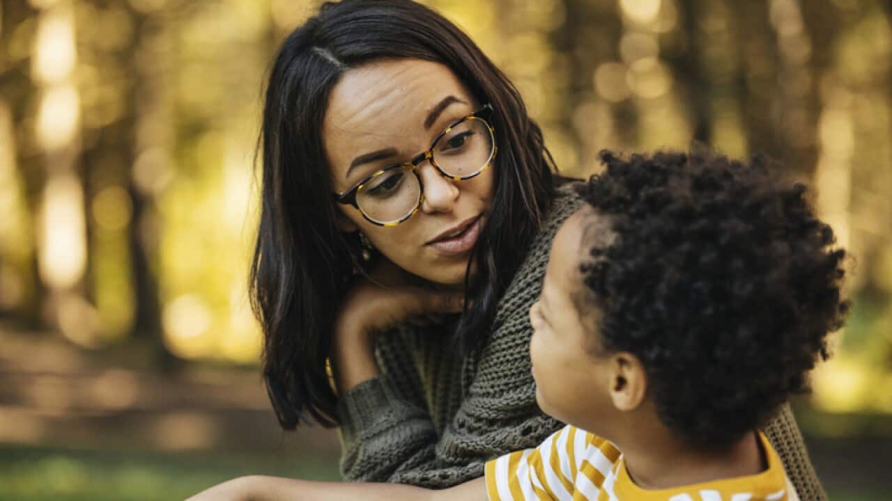 Mother talking to son outdoors