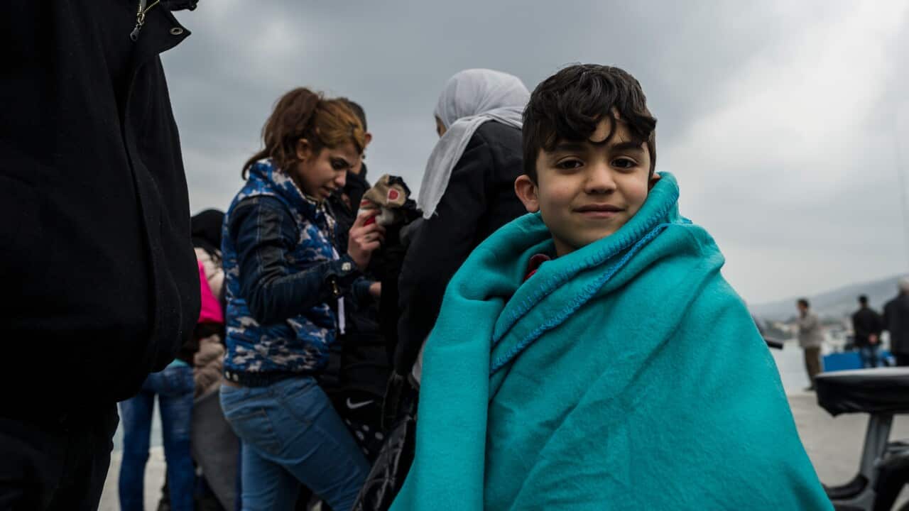 File image of child wrapped in a survival blanket looks on as migrants and refugees arrive on the Greek island of Lesbos after crossing from Turkey in 2016.