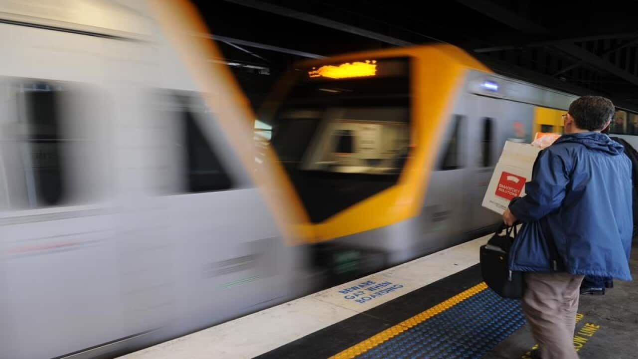 A Sydney train with man standing on the platform