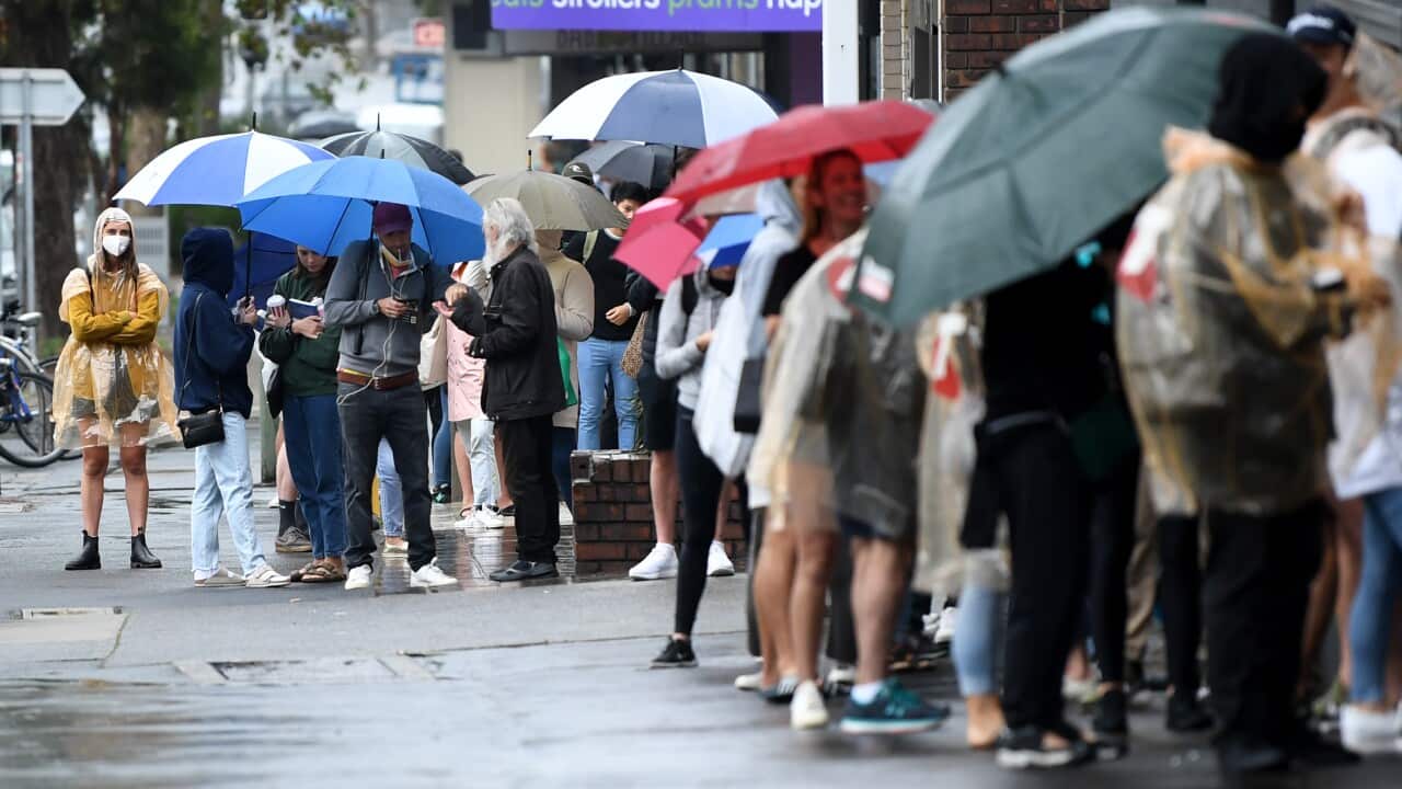 People are seen queuing outside a Centrelink office in Bondi Junction, Sydney, Tuesday, March 24, 2020.