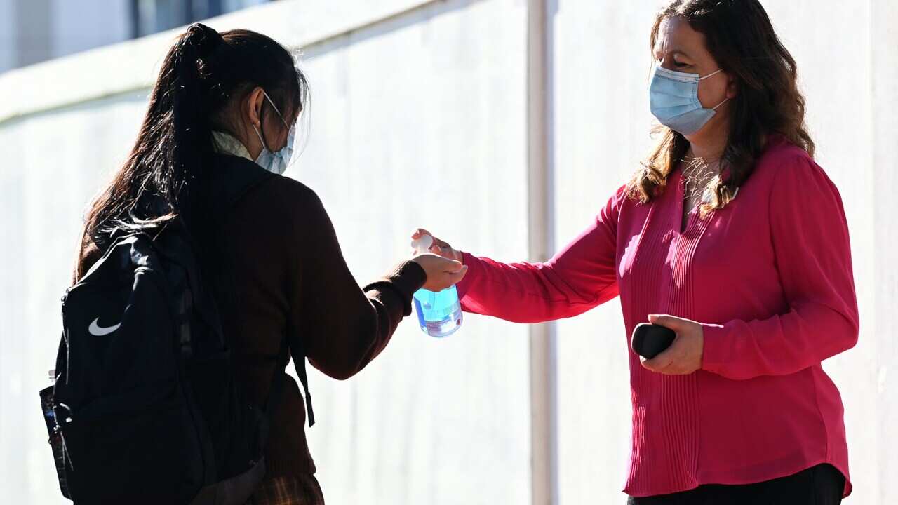 A student applies hand sanitiser in NSW (AAP).