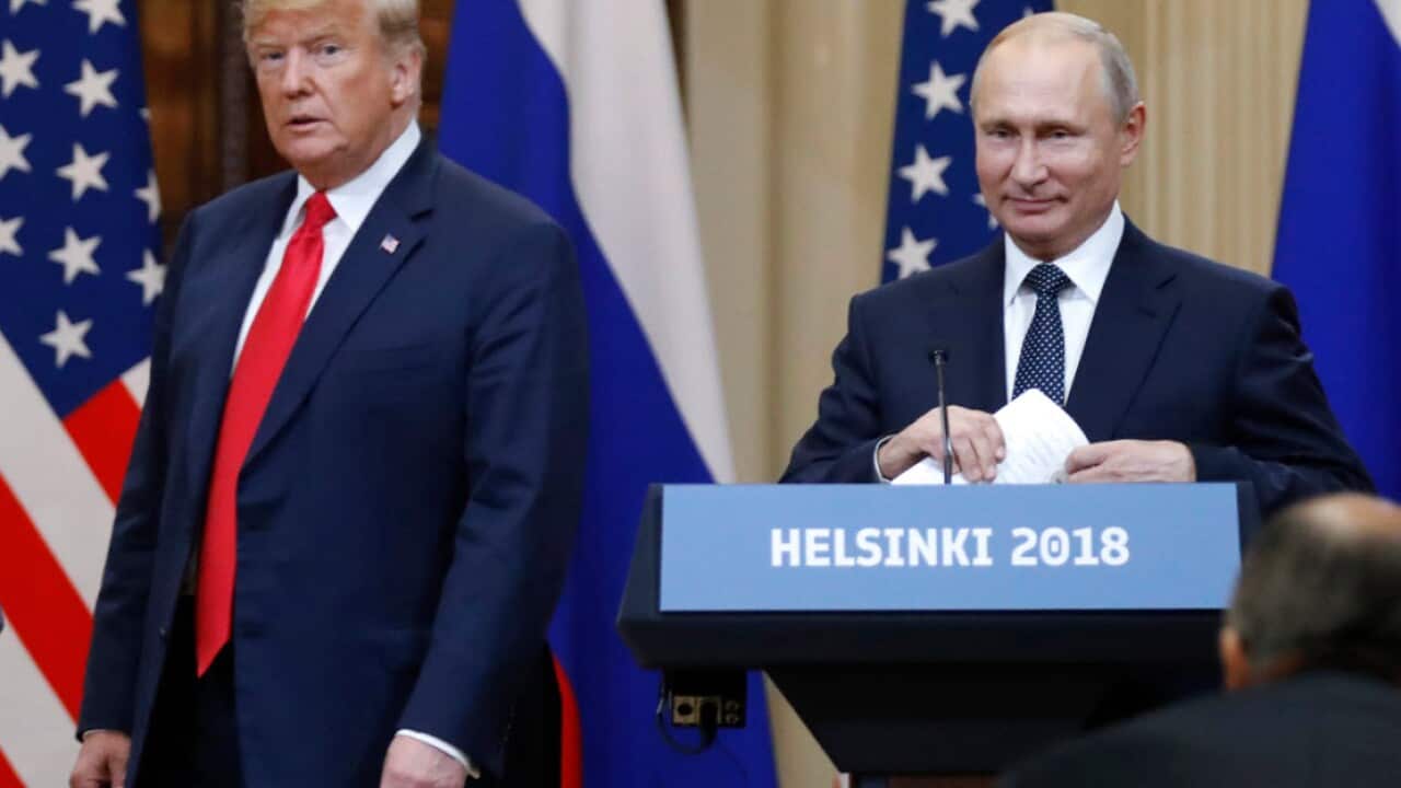 U.S. President Donald Trump, left, and Russian President Vladimir Putin arrive for a press conference after their meeting at the Presidential Palace in Helsinki