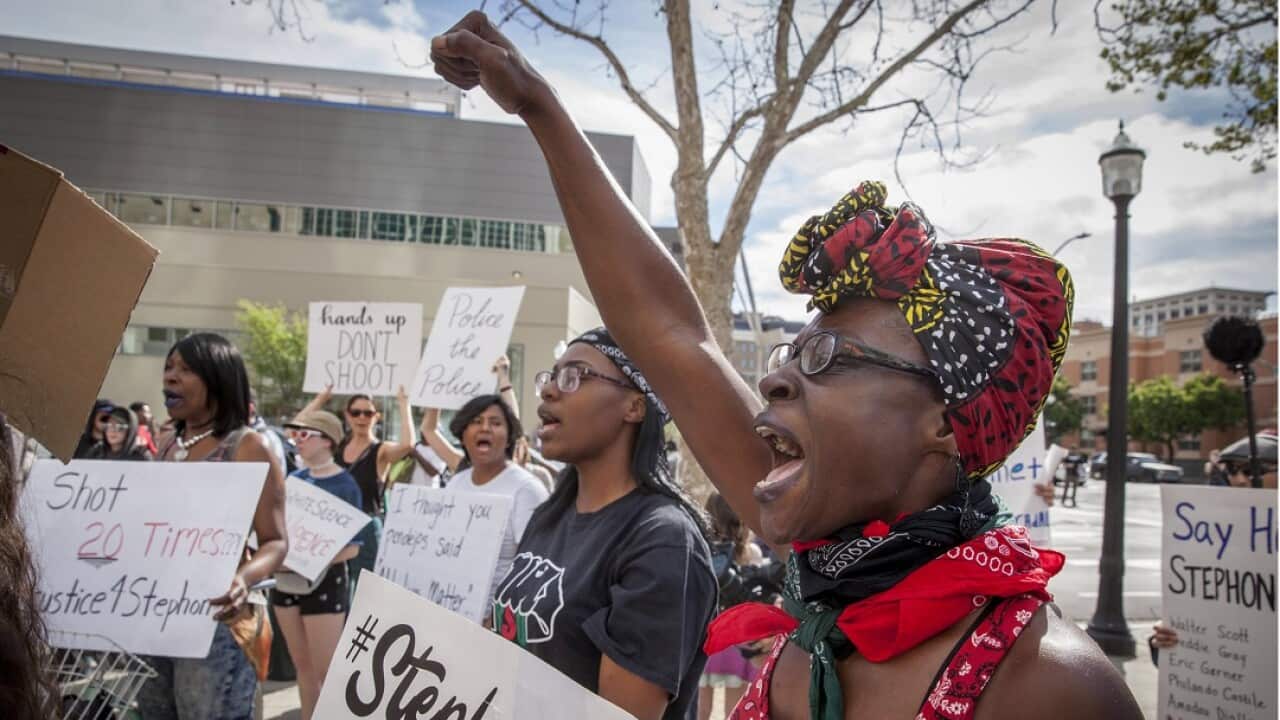 Black Lives Matter protesters chant slogans outside the Federal courthouse in Sacramento just hours after Stephon Clark's funeral.