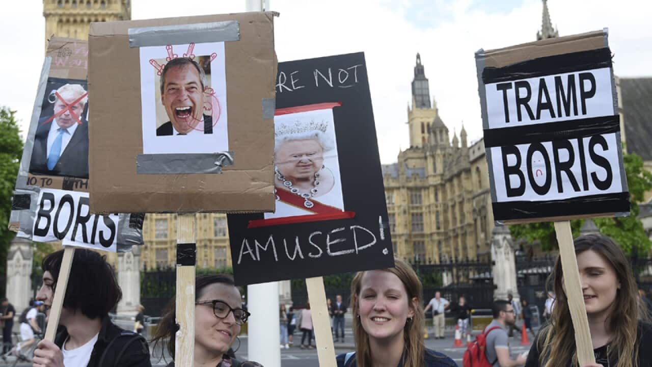 Protestors gather outside the Houses of Parliament in London