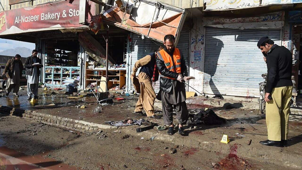 Pakistani security officials examine the site of a bomb blast near a polio vaccination centre in Quetta.