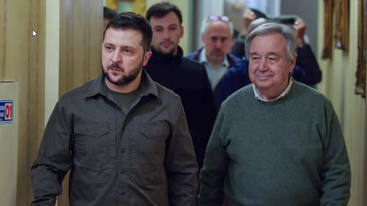 Ukrainian President Volodymyr Zelenskyy, left, and UN Secretary-General Antonio Guterres walk in the hall during their meeting in Kyiv