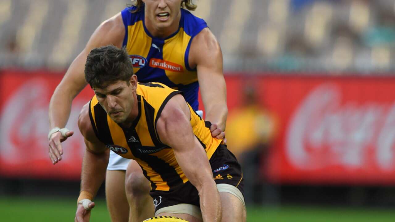Hawthorn's Luke Breust is tackled by West Coast's Jackson Nelson
