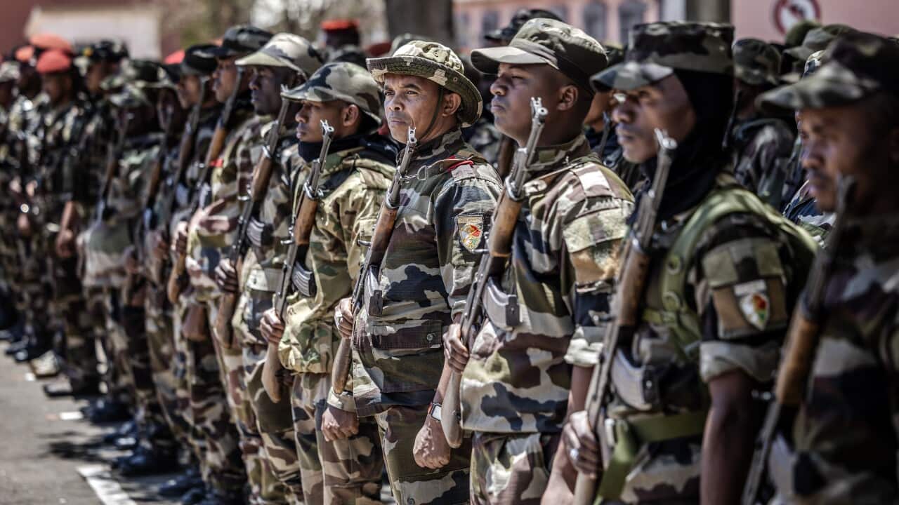 An army unit stands in formation during a ceremony.