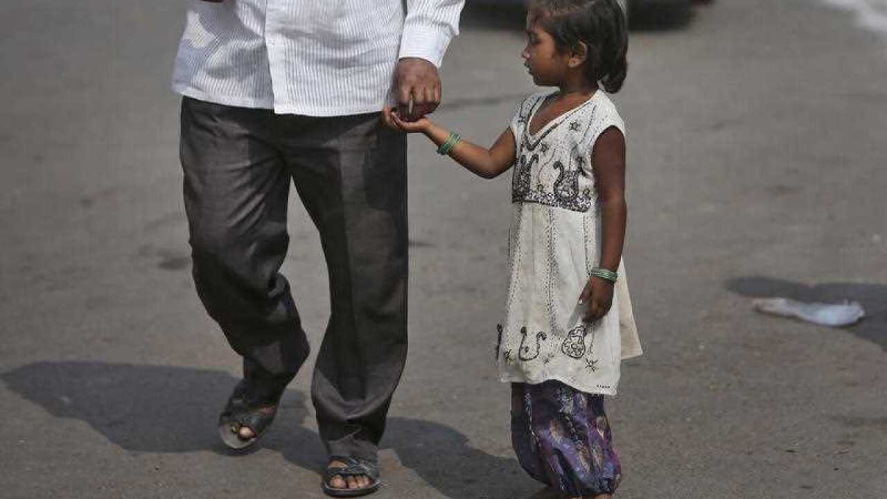 An Indian girl asks for alms at a street on International Day for the Eradication of Poverty in Hyderabad, India, Saturday, Oct. 17, 2015. (AP Photo/Mahesh Kumar A.)