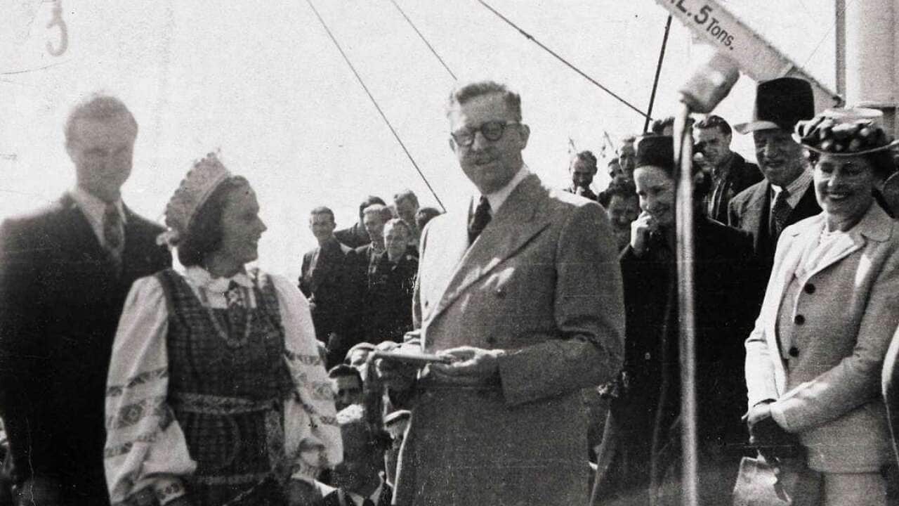 Konstancija Brundzaite presents a gift to Arthur Calwell, Minister for Immigration, 1947.