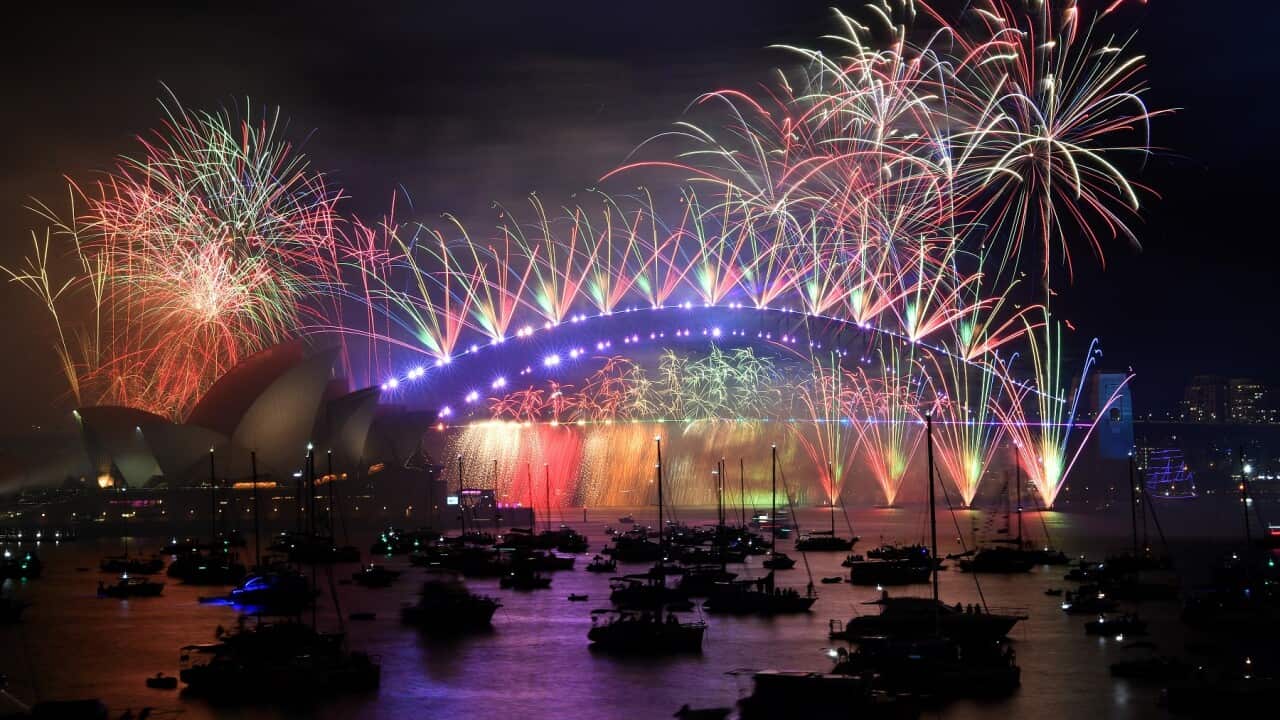 The midnight fireworks are seen over the Sydney Harbour Bridge during New Year’s Eve celebrations in Sydney {AAP)