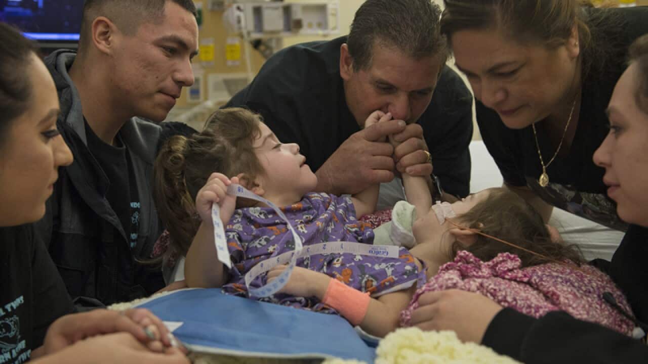 Erika and Eva Sandoval with members of their family